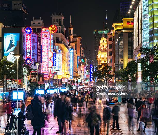 shanghai's nanjing road crowded with pedestrians - nanjing road stock pictures, royalty-free photos & images