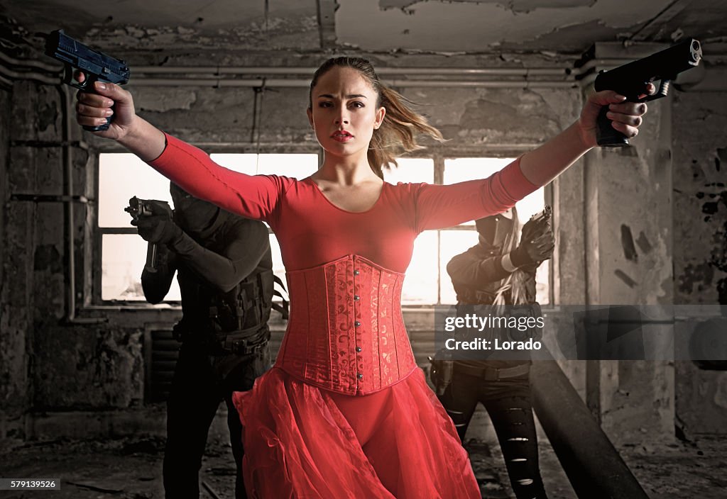 Modern female warrior wearing elegant red dress in urban setting