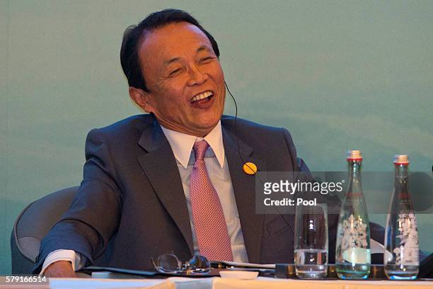Taro Aso,Japan's Deputy Prime Minister attends a panel for the High-level Tax Symposium held in Chengdu in Southwestern China's Sichuan province,...