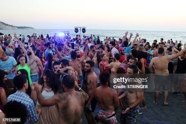 Syrians dance during a party at the Wadi Qandeel beach in the coastal city of Latakia on July 22, 2016.