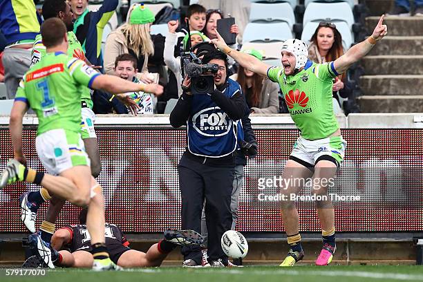 Jarrod Croker of the Raiders celebrates with team mates after scoring a try in golden point during the round 20 NRL match between the Canberra...