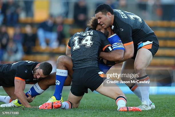 Vitale Roqica of the Newtown Jets is tackled during the round 19 Intrust Super Premiership NSW match between the Wests Tigers and the Newtown Jets at...