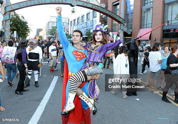 Superman and Mad Hatter cosplayers attend Comic-Con International on July 22, 2016 in San Diego, California.