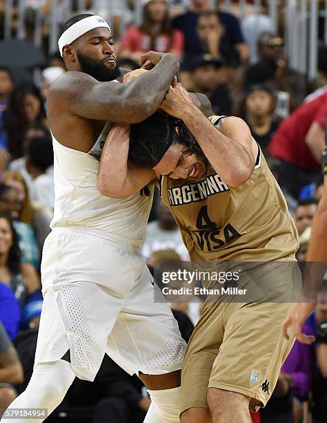 DeMarcus Cousins of the United States fouls Luis Scola of Argentina during a USA Basketball showcase exhibition game at T-Mobile Arena on July 22,...