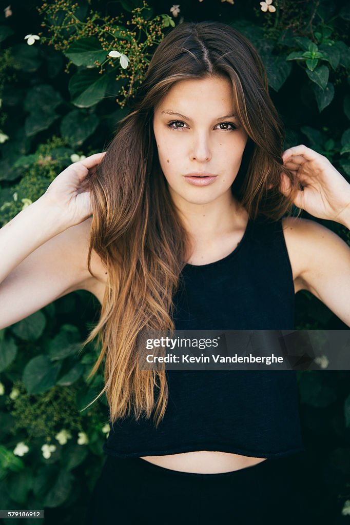 Young woman with hands in her ombre hairstyle