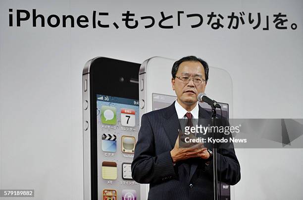 Japan - Takashi Tanaka, president of KDDI Corp., attends a ceremony marking the launch of the iPhone 4S at one of the company's outlets in Tokyo's...