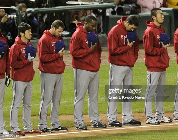 United States - The Texas Rangers' Japanese relievers Yoshinori Tateyama and Koji Uehara listen to the U.S. National anthem before Game 1 of the...