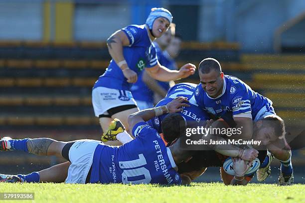 Curtis Sironen of the WestsTigers is tackled during the round 19 Intrust Super Premiership NSW match between the Wests Tigers and the Newtown Jets at...