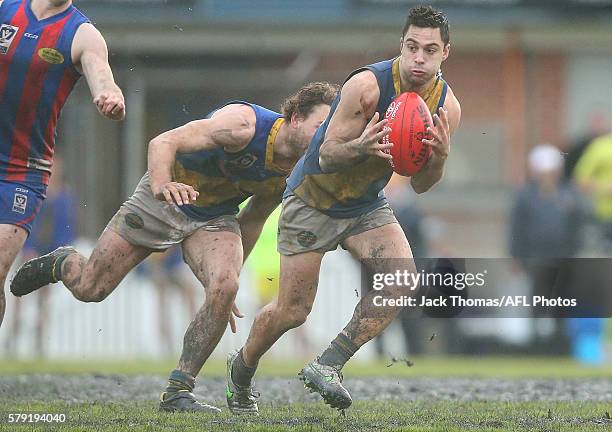 Michael Gibbons of Williamstown runs with the ball during the round 16 VFL match between Port Melbourne and Williamstown at North Port Oval on July...