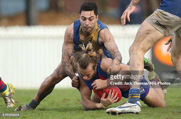 Mack Rivett of Port Melbourne is tackled during the round 16 VFL match between Port Melbourne and Williamstown at North Port Oval on July 23, 2016 in...