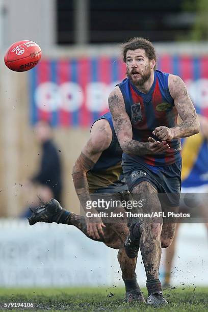 Toby Pinwill of Port Melbourne handballs during the round 16 VFL match between Port Melbourne and Williamstown at North Port Oval on July 23, 2016 in...