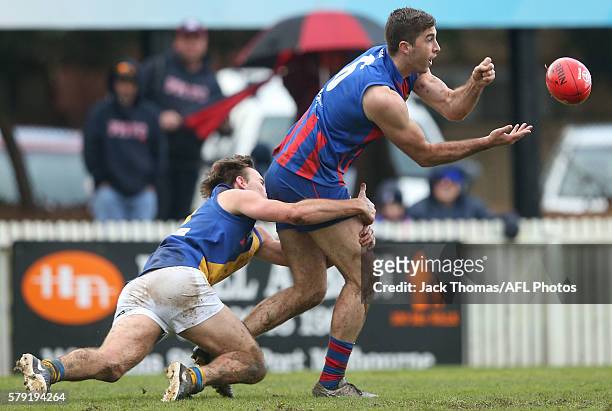 Jordan Lisle of Port Melbourne handballs during the round 16 VFL match between Port Melbourne and Williamstown at North Port Oval on July 23, 2016 in...