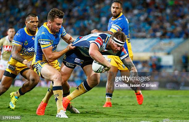 Chris McQueen of the Titans scores a try during the round 20 NRL match between the Gold Coast Titans and the Parramatta Eels at Cbus Super Stadium on...