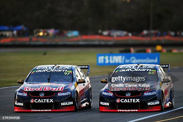 Shane Van Gisbergen drives the Red Bull Racing Australia Holden Commodore VF passes Jamie Whincup drives the Red Bull Racing Australia Holden...