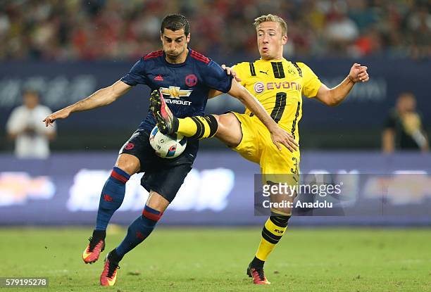 Henrikh Mkhitaryan of Manchester United in action against Felix Passlack of Borussia Dortmund during the friendly match between Manchester United and...