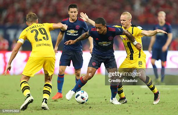 Memphis Depay of Manchester United in action against Sebastian Rode of Borussia Dortmund during the friendly match between Manchester United and...