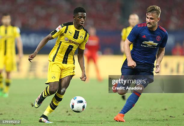 Ousmane Dembele of Manchester United in action against Luke Shaw of Borussia Dortmund during the friendly match between Manchester United and...