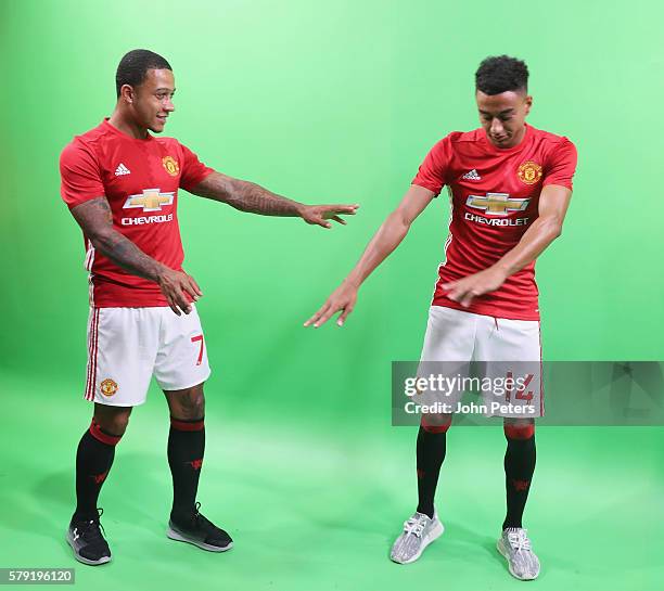 Memphis Depay and Jesse Lingard of Manchester United pose during the official launch of the 2016/17 Manchester United home kit at Century Park on...
