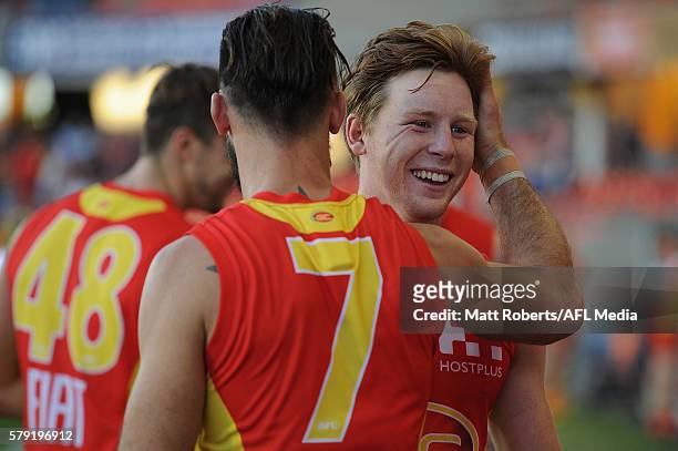Jesse Joyce of the Suns celebrates with Nick Malceski during the round 18 AFL match between the Gold Coast Suns and the Fremantle Dockers at Metricon...