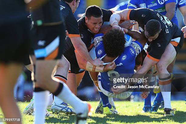 Vitale Roqica of the Newtown Jets is tackled during the round 19 Intrust Super Premiership NSW match between the Wests Tigers and the Newtown Jets at...
