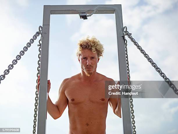 In this handout image provided by Red Bull, Kris Kolanus of Poland prepares to dive from the 27 metre platform on the Saint Nicolas Tower during the...