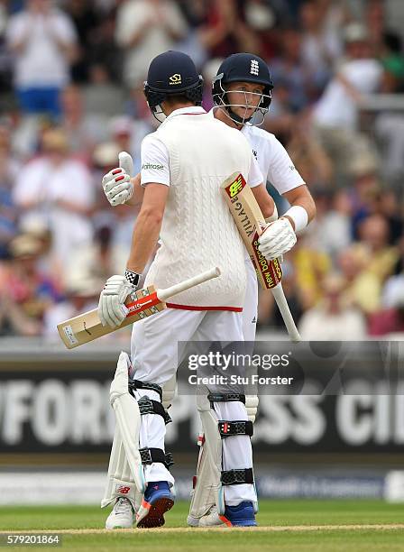 England batsman Joe Root is congratulated by Chris Woakes after reaching 150 during day two of the 2nd Investec Test match between England and...