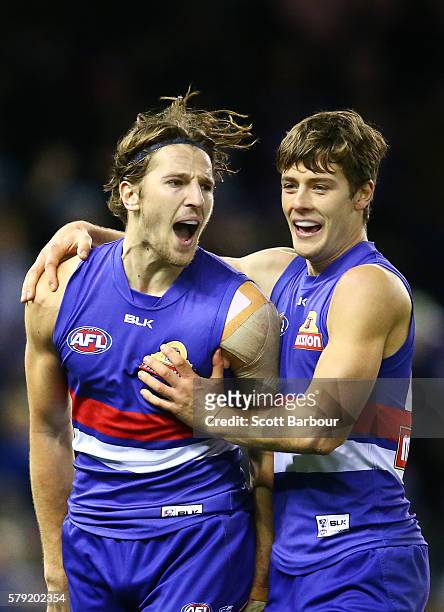 Marcus Bontempelli of the Bulldogs is congratulated by Josh Dunkley of the Bulldogs after kicking a goal during the round 18 AFL match between the...