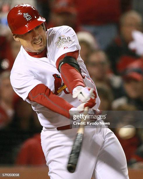 United States - Allen Craig of the St. Louis Cardinals hits an RBI single in the seventh inning of Game 2 in the World Series against the Texas...