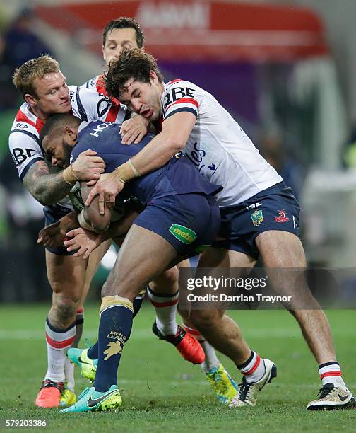 Marika Koroibete of the Storm is tackled during the round 20 NRL match between the Melbourne Storm and the Sydney Roosters at AAMI Park on July 23,...