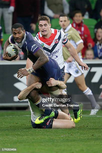 Suliasi Vunivalu of the Storm is tackled during the round 20 NRL match between the Melbourne Storm and the Sydney Roosters at AAMI Park on July 23,...