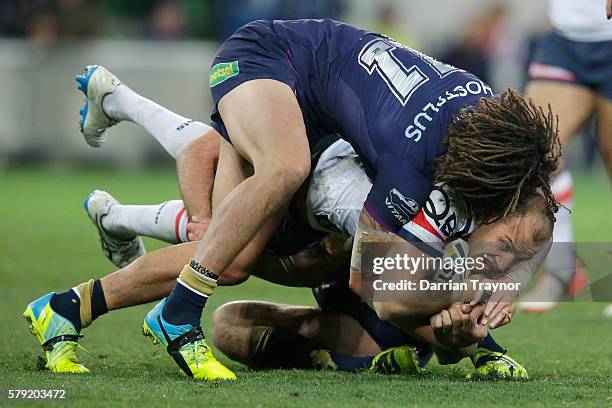 Kevin Proctor of the Storm tackles Blake Ferguson of the Roosters during the round 20 NRL match between the Melbourne Storm and the Sydney Roosters...