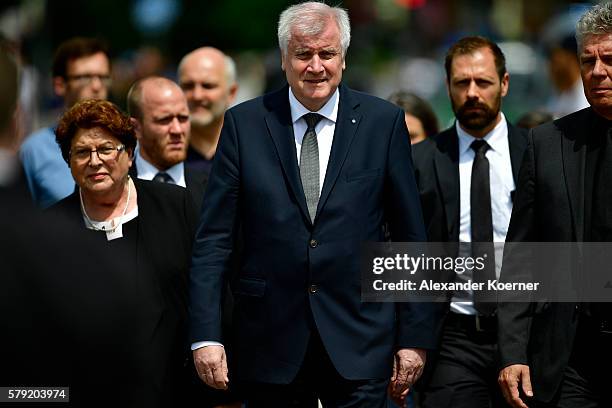 State Minister of Bavaria Horst Seehofer attends a wreath-lying ceremony outside the OEZ shopping center the day after a shooting spree left nine...