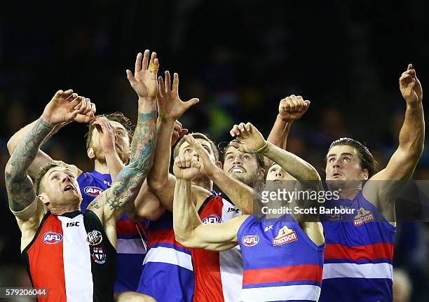 Tim Membrey , Nick Riewoldt and Maverick Weller of the Saints compete for the ball with Easton Wood and Tom Boyd of the Bulldogs during the round 18...