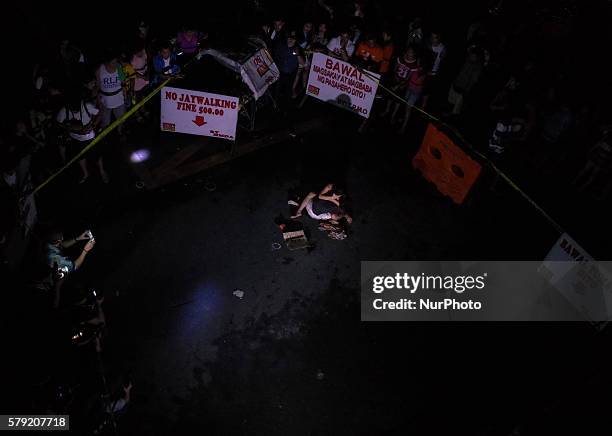 Woman cries for help as she holds an alleged drug pusher that she identifies as her husband, early Saturday morning of 23 July 2016 in Pasay City,...