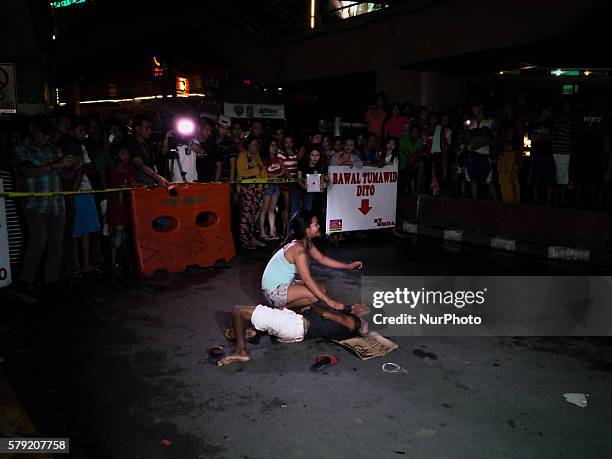 Woman cries for help as she holds an alleged drug pusher that she identifies as her husband, early Saturday morning of 23 July 2016 in Pasay City,...