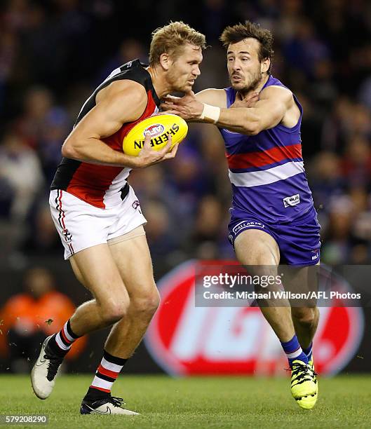 Sam Gilbert of the Saints is tackled by Tory Dickson of the Bulldogs during the 2016 AFL Round 18 match between the Western Bulldogs and the St Kilda...