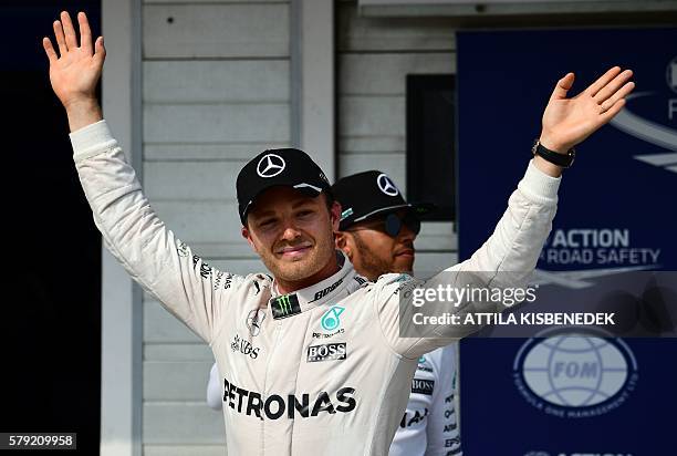 First placed Mercedes AMG Petronas F1 Team's German driver Nico Rosberg celebrates his pole position, with his teammate second placed British driver...