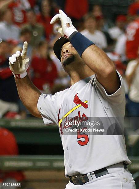 United States - St. Louis Cardinals' Albert Pujols reacts after hitting a home run during the ninth inning of Game 3 of the World Series against the...