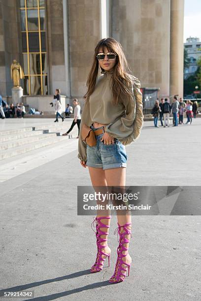 Fashion blogger Doina Ciobanu wears a Phillip Lim blouse, Christian Louboutin shoes and Dior sunglasses on day 3 of Paris Haute Couture Fashion Week...