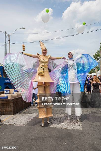 baltimore maryland artscape 2016 -- female costumed stilt walkers - baltimore maryland daytime stock pictures, royalty-free photos & images