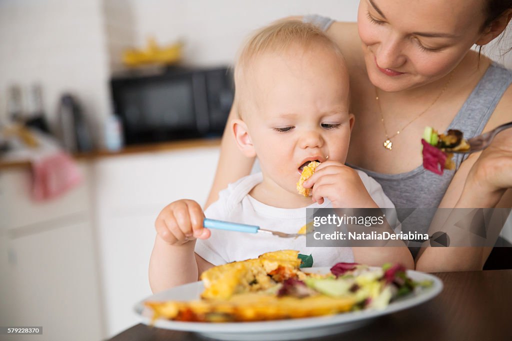 Mother and child eating together