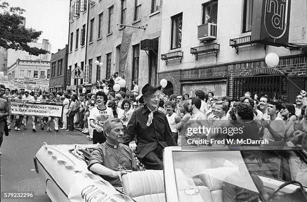 English author Quentin Crisp , with the Church of the Beloved Disciple's Father John Darcy Noble and Bishop Robert Clement, in the lead car of the...