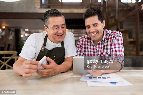 men doing the books at a restaurant - business consultant male stock pictures, royalty-free photos & images
