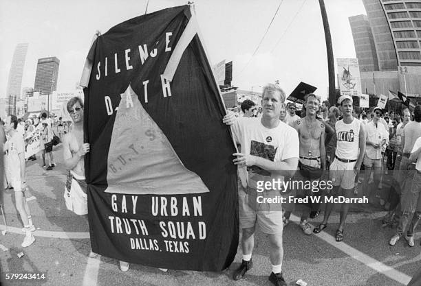 Members of the Gay Urban Truth Squad with a 'Silence Equals Death' banner demonstrate outside the Omni Hotel during the Democratic National...
