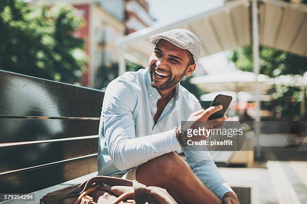 Young man laughing at a text message