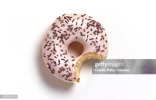 bite out of white doughnut - buñuelo en forma de rosca fotografías e imágenes de stock