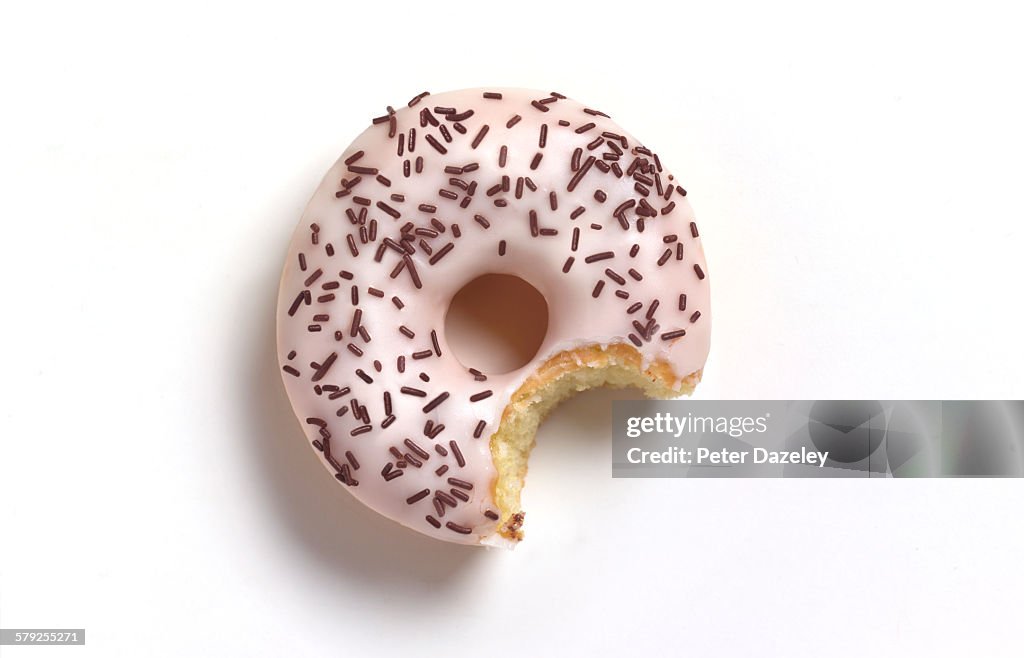Bite out of white doughnut