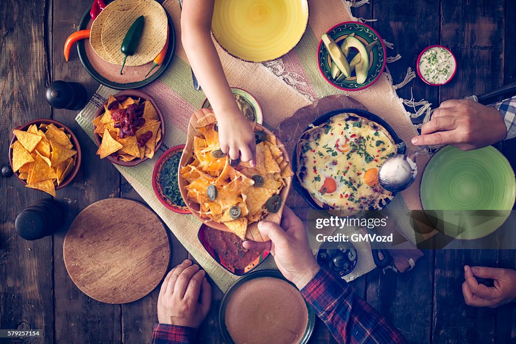 Eating Mexican Eggs and Tortilla Chips with Salsa and Jalapenos