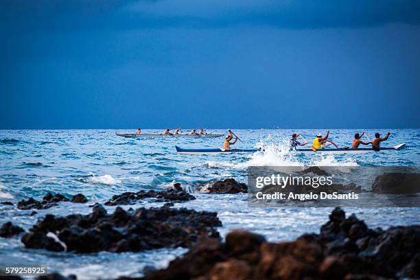 paddling at dusk - maui water stock pictures, royalty-free photos & images