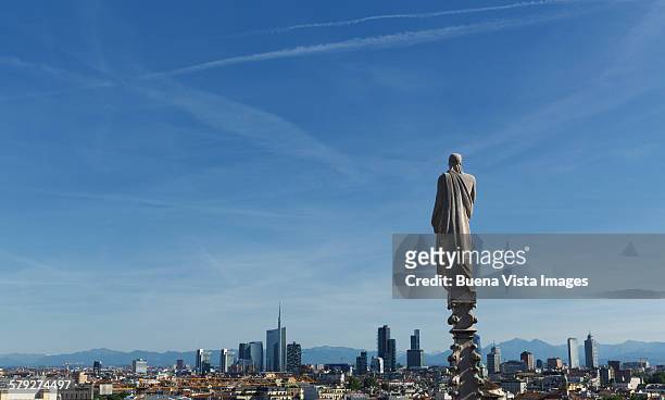 statue on the top of the milan cathedral - spire stock pictures, royalty-free photos & images